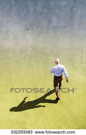 Stock Image - High angle view of a man walking in a park, New York City, New York State, USA. Fotosearch