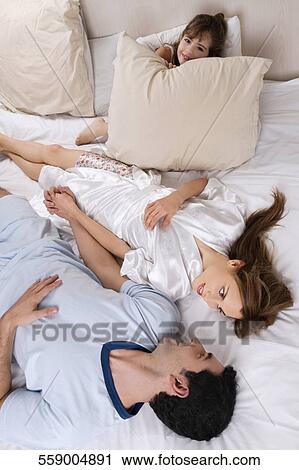 High angle view of a mid adult couple lying on the bed View Large Photo Image Stock Image - High angle view of a mid adult couple lying on the bed. Fotosearch