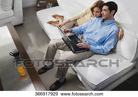 High angle view of a mid adult couple using a laptop View Large Photo Image Stock Photo - High angle view of a mid adult couple using a laptop. Fotosearch