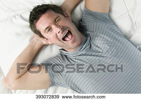 High angle view of a mid adult man winking and shouting View Large Photo Image Stock Photo - High angle view of a mid adult man winking and shouting. Fotosearch