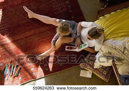High angle view of a mid adult woman teaching her daughter View Large Photo Image Stock Image - High angle view of a mid adult woman teaching her daughter. Fotosearch