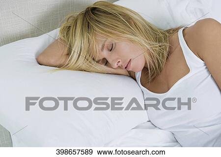 High angle view of a mid adult woman sleeping on the bed View Large Photo Image Stock Photo - High angle view of a mid adult woman sleeping on the bed. Fotosearch