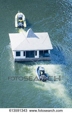 High angle view of a motor boat pulling a boathouse and another motorboat, Miami River, Miami, Florida, USA View Large Photo Image Stock Image - High angle view of a motor boat pulling a boathouse and another motorboat, Miami River, Miami, Florida, USA. Fotosearch