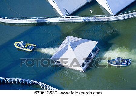High angle view of a motor boat pulling a boathouse and another motorboat, Miami River, Miami, Florida, USA View Large Photo Image Stock Image - High angle view of a motor boat pulling a boathouse and another motorboat, Miami River, Miami, Florida, USA. Fotosearch