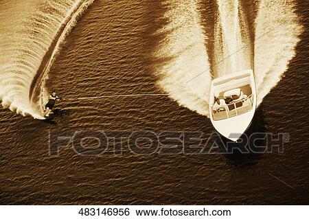 Stock Photograph - High angle view of a person wakeboarding. Fotosearch
