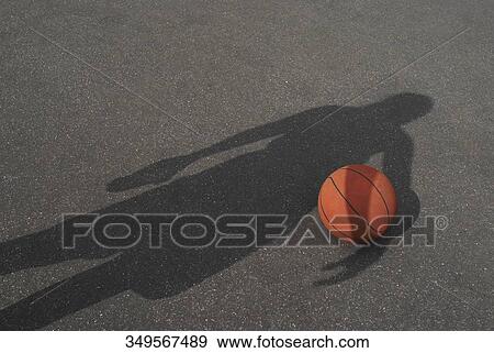 High angle view of a shadow over a basketball View Large Photo Image Stock Photo - High angle view of a shadow over a basketball. Fotosearch