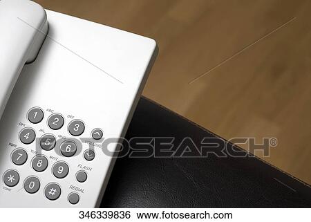 Stock Photograph - High angle view of a telephone on a wallet. Fotosearch