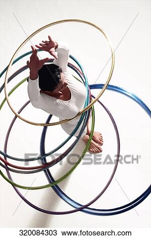 High angle view of a woman exercising with hula hoops View Large Photo Image Stock Image - High angle view of a woman exercising with hula hoops. Fotosearch