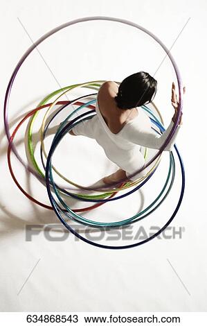 High angle view of a woman exercising with hula hoops View Large Photo Image Stock Image - High angle view of a woman exercising with hula hoops. Fotosearch