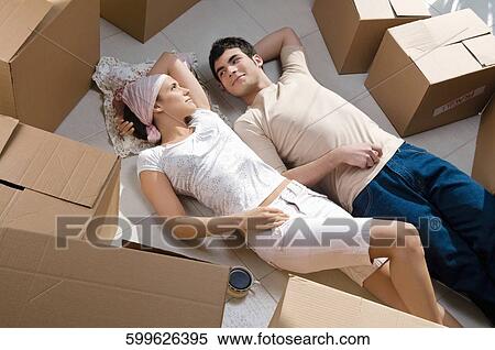 High angle view of a young couple lying on the floor View Large Photo Image Stock Photography - High angle view of a young couple lying on the floor. Fotosearch