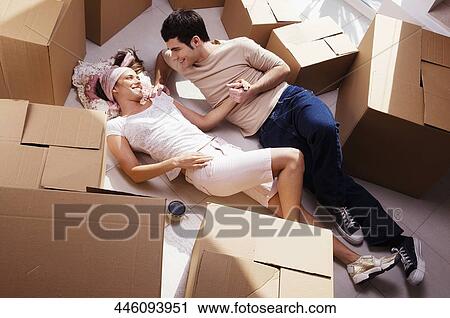 Stock Image - High angle view of a young couple romancing. Fotosearch