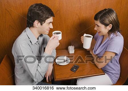 High angle view of a young couple having coffee in a cafe View Large Photo Image Stock Photograph - High angle view of a young couple having coffee in a cafe. Fotosearch