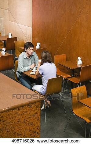 High angle view of a young couple having coffee in a cafe View Large Photo Image Stock Photograph - High angle view of a young couple having coffee in a cafe. Fotosearch