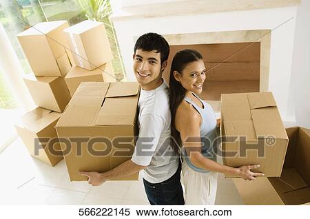 High angle view of a young couple carrying cardboard boxes View Large Photo Image Stock Photography - High angle view of a young couple carrying cardboard boxes. Fotosearch