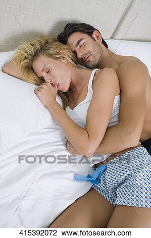 High angle view of a young man and a mid adult woman lying on the bed View Large Photo Image Stock Image - High angle view of a young man and a mid adult woman lying on the bed. Fotosearch