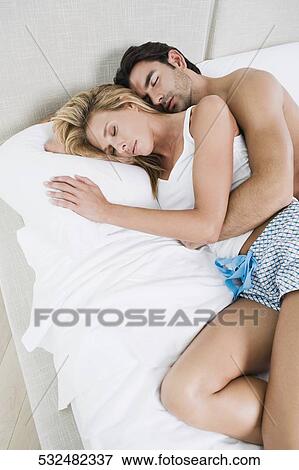 High angle view of a young man and a mid adult woman lying on the bed View Large Photo Image Stock Photo - High angle view of a young man and a mid adult woman lying on the bed. Fotosearch