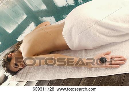 High angle view of a young woman getting hot stone therapy View Large Photo Image Stock Photo - High angle view of a young woman getting hot stone therapy. Fotosearch