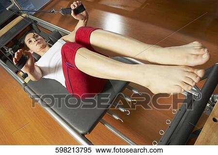 High angle view of a young woman exercising in the gym View Large Photo Image Stock Photography - High angle view of a young woman exercising in the gym. Fotosearch