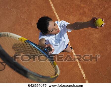 Stock Photography - High angle view of a young woman playing tennis. Fotosearch