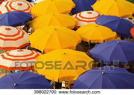 Stock Image - High angle view of beach umbrellas, Vernazza, Cinque Terre National Park, Cinque Terre, La Spezia Province, Liguria, Italy. Fotosearch
