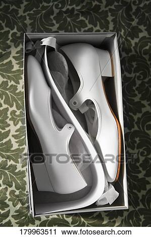 Stock Image - High angle view of shoes in a shoebox. Fotosearch