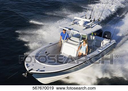 Stock Photo - High angle view of tourists on a speedboat. Fotosearch