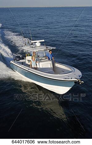 Stock Photograph - High angle view of tourists on a speedboat. Fotosearch