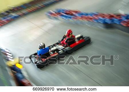 High angle view of two people go-carting on a motor racing track View Large Photo Image Stock Image - High angle view of two people go-carting on a motor racing track. Fotosearch