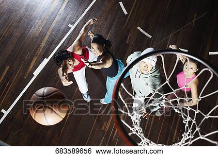 High angle view of two young men with two young women playing basketball View Large Photo Image Stock Photograph - High angle view of two young men with two young women playing basketball. Fotosearch