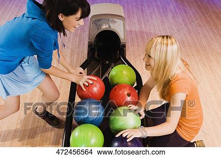 High angle view of two young women smiling in a bowling alley View Large Photo Image Picture - High angle view of two young women smiling in a bowling alley. Fotosearch
