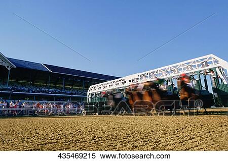 Jockeys riding their horses on a running track View Large Photo Image Stock Photography - Jockeys riding their horses on a running track. Fotosearch