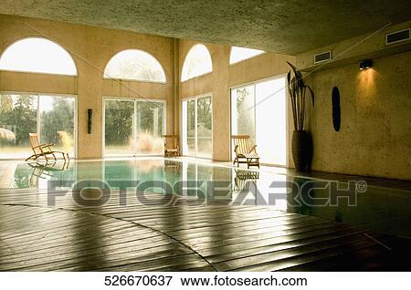 Stock Photo - Lounge chairs at the poolside. Fotosearch