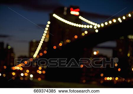 Low angle view of a bridge lit up at dusk, Brooklyn Bridge, Manhattan, New York City, New York State, USA View Large Photo Image Stock Photography - Low angle view of a bridge lit up at dusk, Brooklyn Bridge, Manhattan, New York City, New York State, USA. Fotosearch