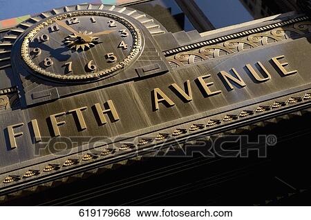 Low angle view of a clock and texts on a wall of a building, Fifth Avenue, Manhattan, New York City, New York State, USA View Large Photo Image Stock Photo - Low angle view of a clock and texts on a wall of a building, Fifth Avenue, Manhattan, New York City, New York State, USA. Fotosearch