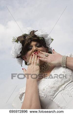 Stock Photograph - Low angle view of a gay man blowing a kiss. Fotosearch