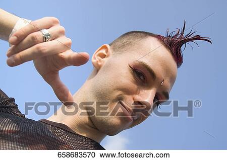 Stock Image - Low angle view of a gay man gesturing. Fotosearch