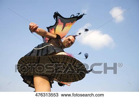 Low angle view of a gay man showing his shoe sole View Large Photo Image Stock Image - Low angle view of a gay man showing his shoe sole. Fotosearch
