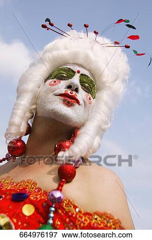 Low angle view of a gay man with face paint on his face View Large Photo Image Stock Photo - Low angle view of a gay man with face paint on his face. Fotosearch