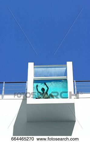 Low angle view of a man bathing in a water tank View Large Photo Image Stock Image - Low angle view of a man bathing in a water tank. Fotosearch
