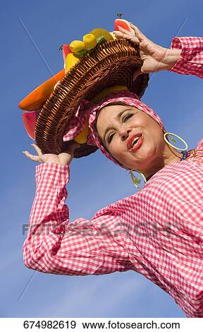 Low angle view of a mature woman selling fruits View Large Photo Image Stock Photo - Low angle view of a mature woman selling fruits. Fotosearch