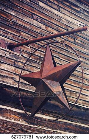 Low angle view of a metallic star hanging on a pole of a wall, Ghost Town, Nevada City, Montana View Large Photo Image Stock Image - Low angle view of a metallic star hanging on a pole of a wall, Ghost Town, Nevada City, Montana. Fotosearch