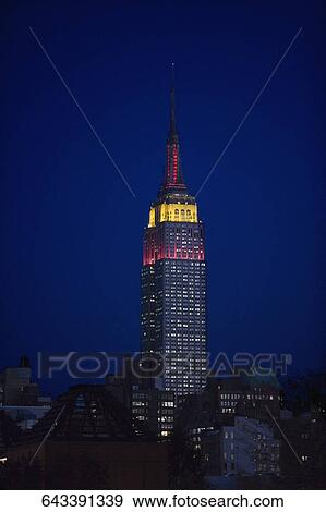 Stock Photo - Low angle view of a skyscraper lit up at night, Empire State Building, Manhattan, New York City, New York State, USA. Fotosearch