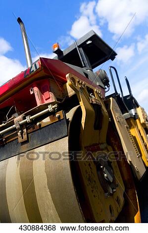 Stock Photo - Low angle view of a steamroller at construction site. Fotosearch