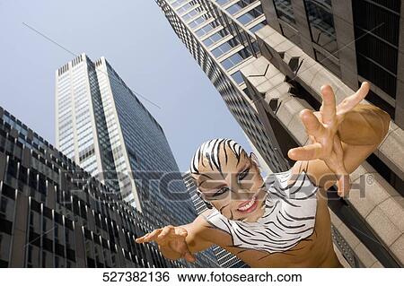 Low angle view of a young man imitating to be a tiger, New York City, New York State, USA View Large Photo Image Stock Photograph - Low angle view of a young man imitating to be a tiger, New York City, New York State, USA. Fotosearch