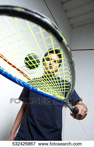 Low angle view of a young man playing tennis View Large Photo Image Stock Photo - Low angle view of a young man playing tennis. Fotosearch