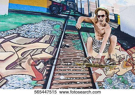Stock Photography - Low angle view of a young man skateboarding. Fotosearch
