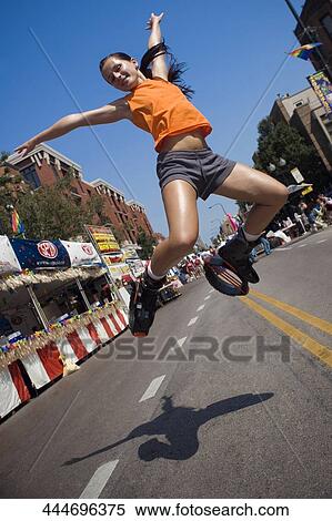 Low angle view of a young woman jumping View Large Photo Image Stock Photography - Low angle view of a young woman jumping. Fotosearch