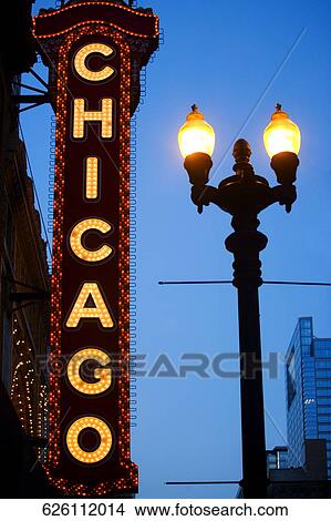 Picture - Low angle view of Chicago neon sign lit up at dusk, Chicago Theatre, Chicago, Illinois, USA. Fotosearch