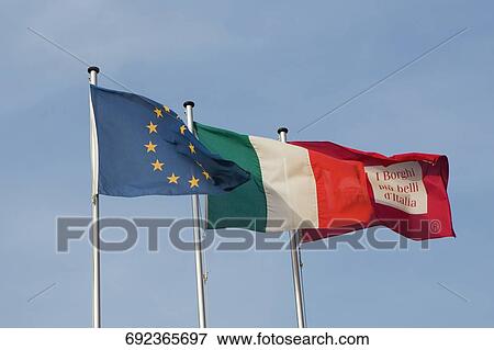 Stock Photo - Low angle view of flags fluttering, Italian Riviera, Genoa, Liguria, Italy. Fotosearch