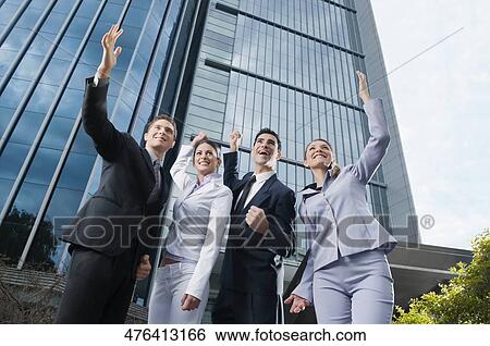 Low angle view of four business executives standing with their hands raised View Large Photo Image Stock Photograph - Low angle view of four business executives standing with their hands raised. Fotosearch